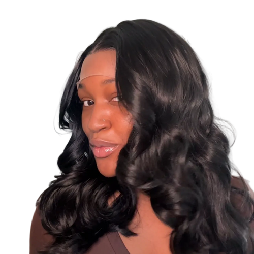 Woman with long, wavy hair wearing a brown top against a neutral background